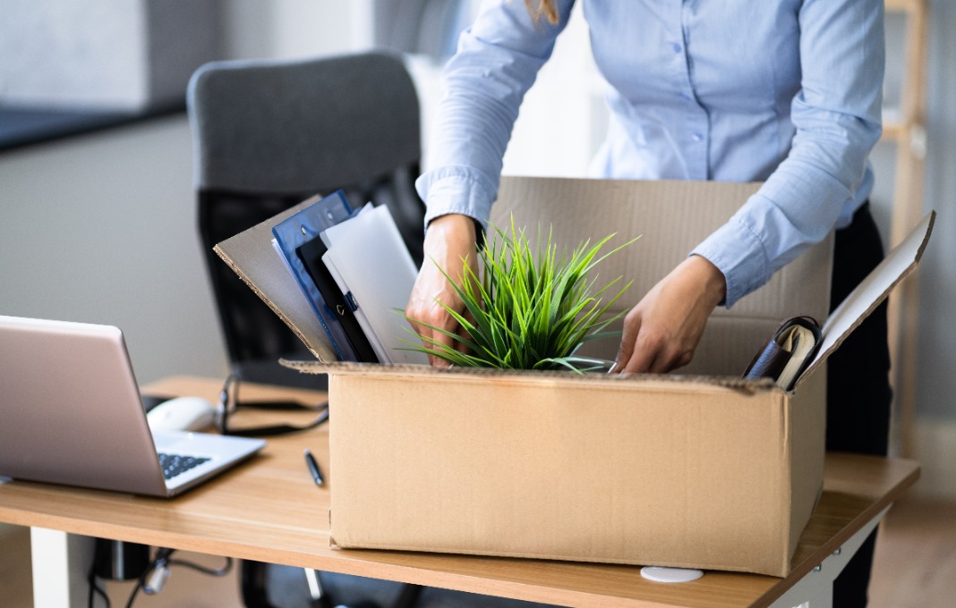 Business woman packing up belongings in her office