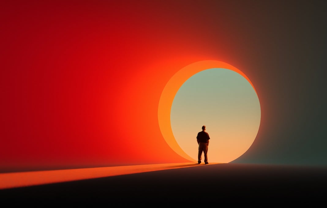 Man facing circular glowing entrance in colorful scene.