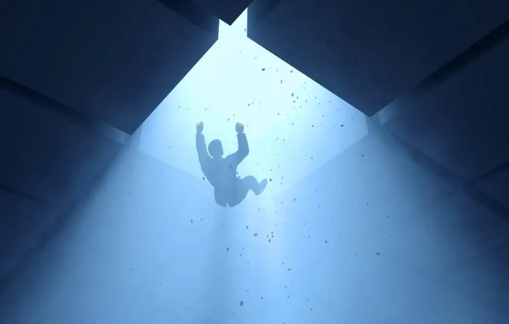 man falling into a hole