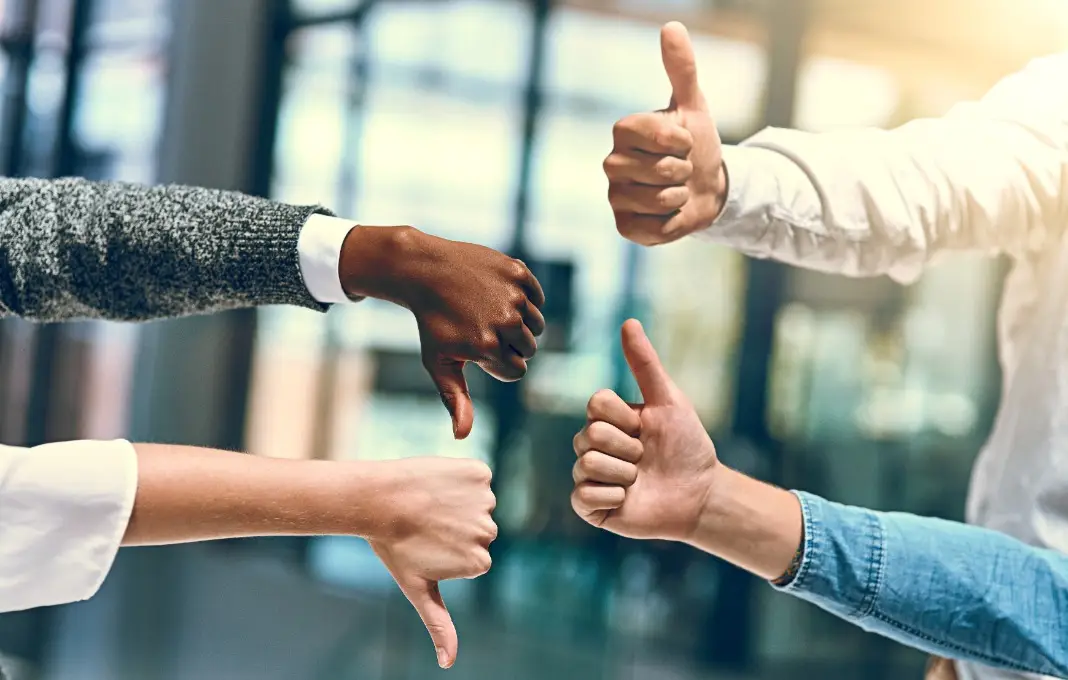 Business people with thumbs up and down