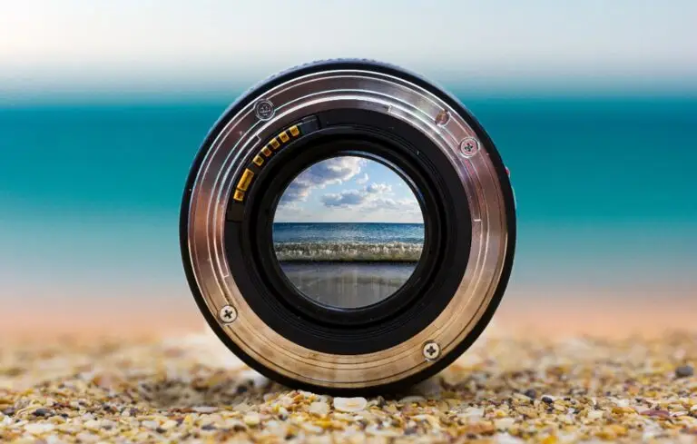 View of the sea surf through a photographic lens lying on a sandy beach on a sunny day.