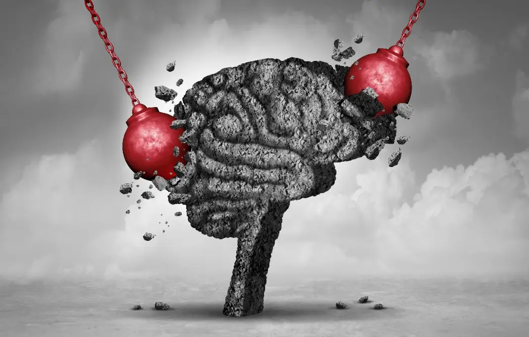 Wrecking balls knocking into brain made out of stone